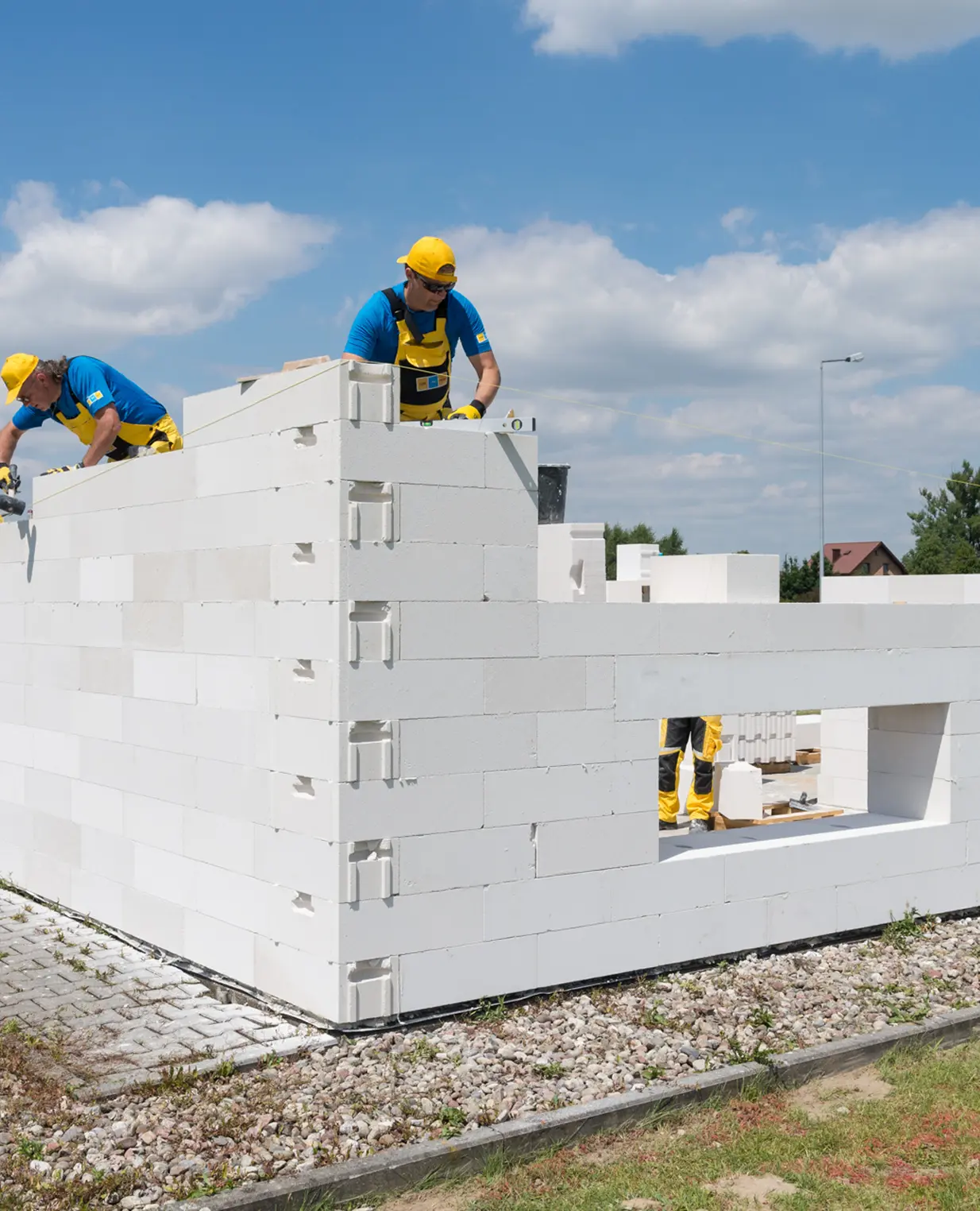 Construction workers laying blocks